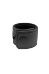 A black leather ball stretcher finished with matte black components, formed into a loop.