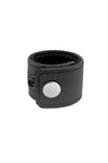 Curled presentation of a black leather ball stretcher with stainless steel details.
