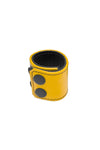 A yellow leather ball stretcher with matte black hardware is shown in a curl.