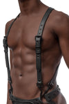 A fit model in three quarter pose in an Australian made 1" wide black leather full body harness with matte black hardware.