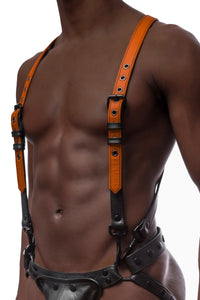 A Black model facing forward in a 1" wide ARMY OF MEN orange and black leather full body harness with matte black hardware