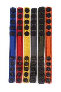 Six ARMY OF MEN 3/4" wide COCKRING NARROW - Colour with matte black snaps, laid flat showing the coloured fronts.