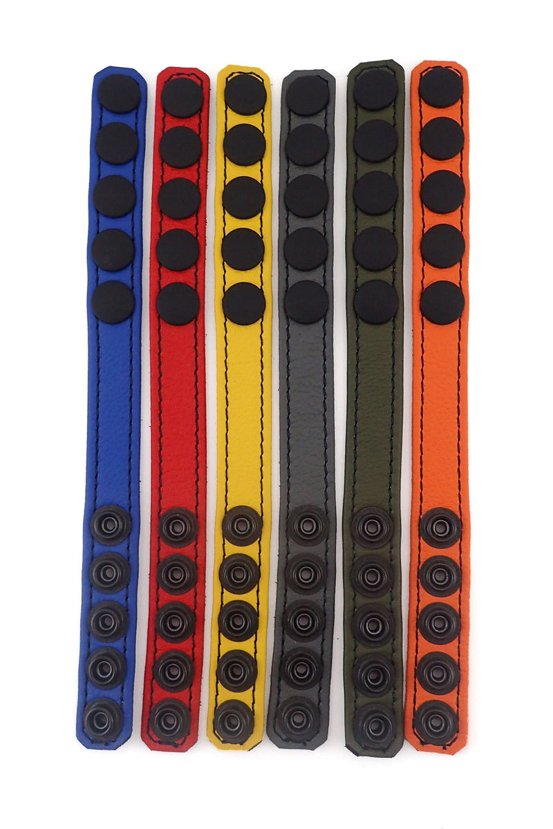 Six ARMY OF MEN 3/4" wide COCKRING NARROW - Colour with matte black snaps, laid flat showing the coloured fronts.