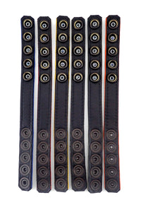 Six 3/4" wide coloured cockrings laid flat, displaying the black lining.