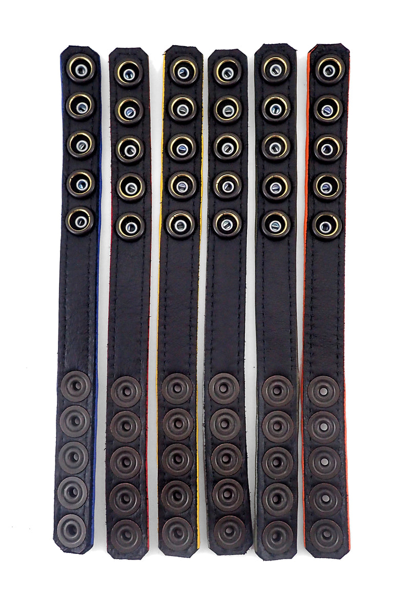 Six 3/4" wide coloured cockrings laid flat, displaying the black lining.