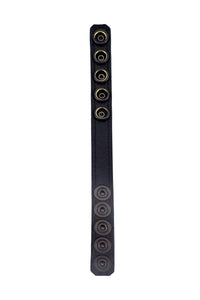 Displayed flat, a black leather cockring reveals its black leather lining.