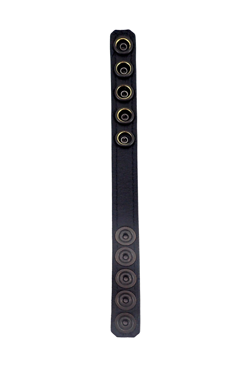 Displayed flat, a black leather cockring reveals its black leather lining.