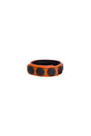 A curled orange leather cockring with matte black components.