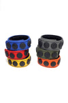 Six coloured leather cockrings finished with matte black components, in two stacks.
