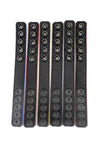 Flat view of six 1" wide coloured cockrings with black leather lining visible.