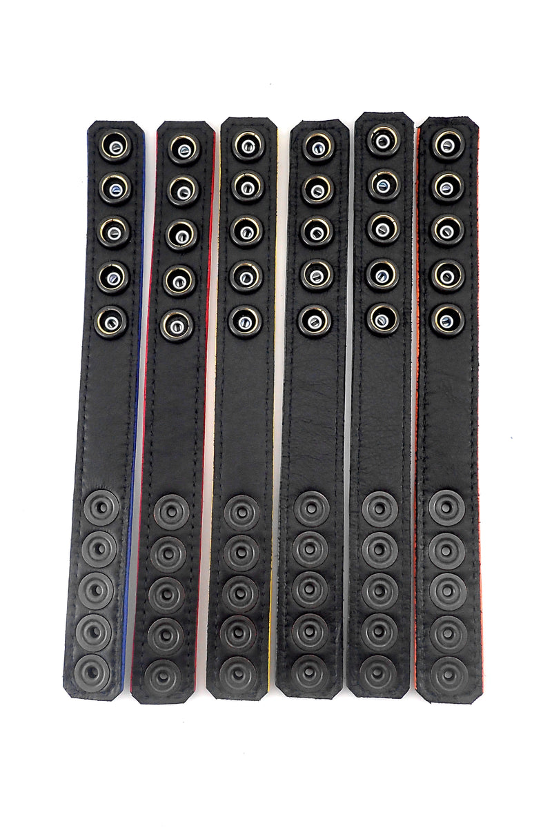 Flat view of six 1" wide coloured cockrings with black leather lining visible.
