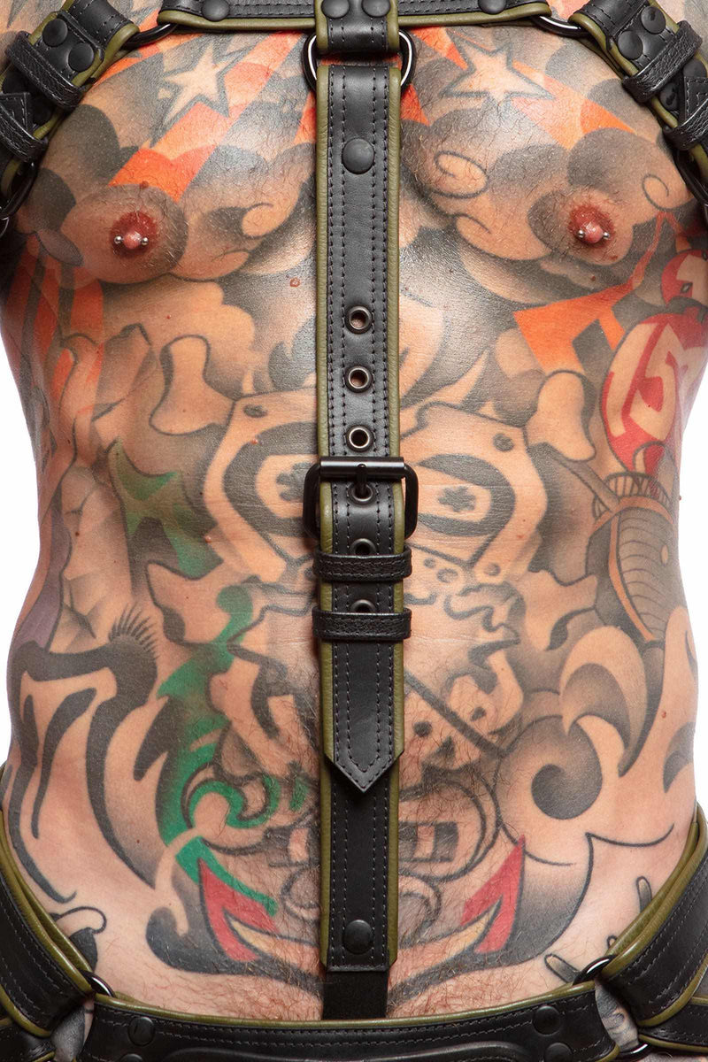 A toned model wearing a 1.5" wide ARMY OF MEN army green leather cockstrap with a matte black buckle, close-up view.