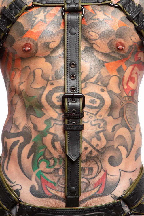 A toned model wearing a 1.5" wide ARMY OF MEN army green leather cockstrap with a matte black buckle, close-up view.