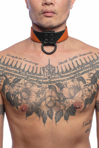 Front-on shot of tattooed model wearing a 1.5" wide ARMY OF MEN black and orange leather collar with matte black hardware.