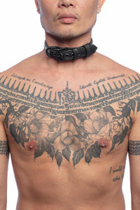 Front view of an Asian model in a 1" wide ARMY OF MEN COMBAT COLLAR NARROW - Black with black rivets, buckle, and D-ring.