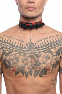 A striking model facing forward wearing a 1" wide ARMY OF MEN black and red leather collar with matte black hardware.