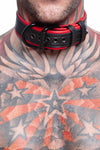 Tight shot of tattooed model wearing a 1.5" wide ARMY OF MEN COMBAT COLLAR WIDE - Red with matte black hardware.