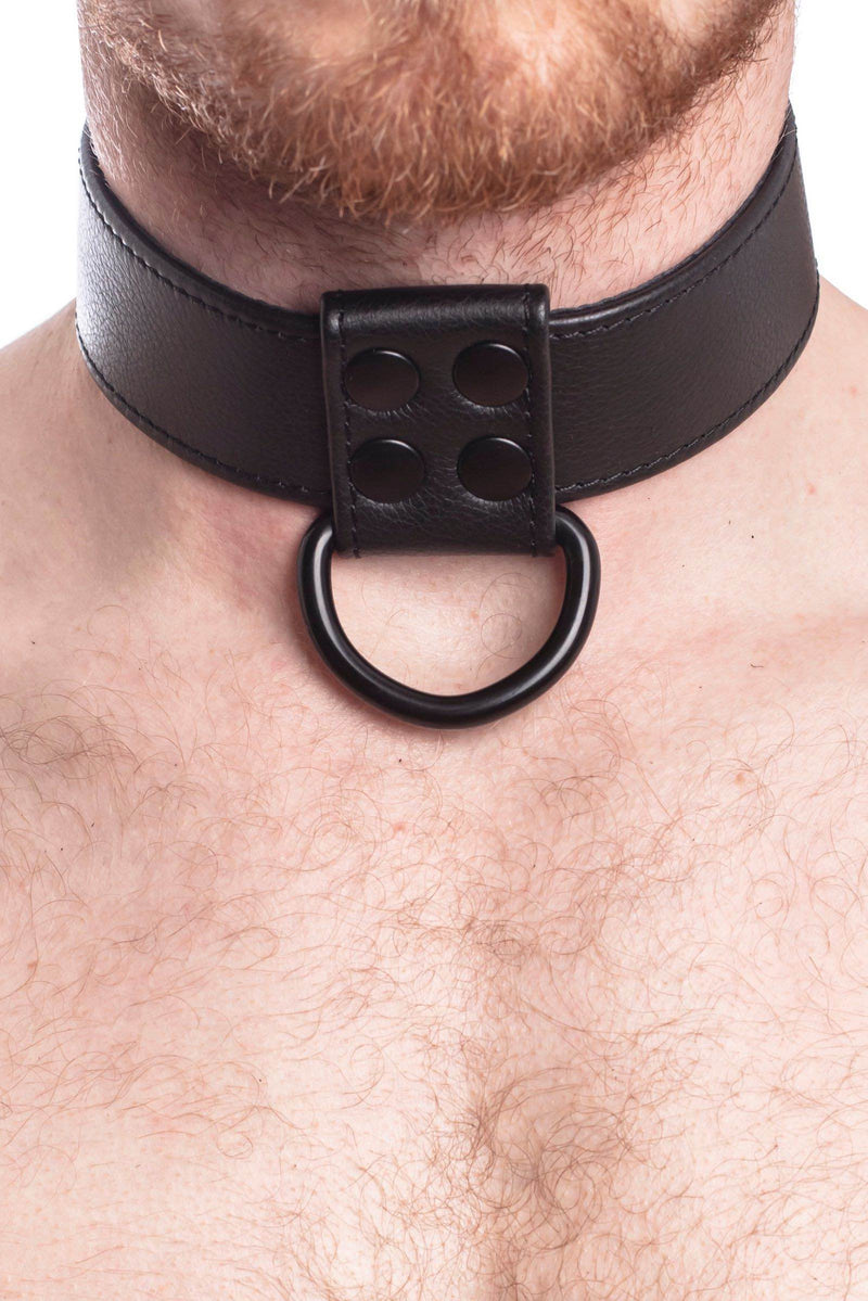 A 1.5" wide ARMY OF MEN black leather D-ring collar with matte black D-ring, worn by a bearded model, close-up view.
