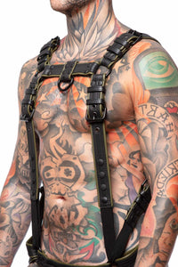 Muscular male model in three-quarter pose in a black and army green leather Full Combat Kit, connected to a jockstrap.