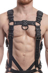 A 1.5" wide ARMY OF MEN FULL COMBAT KIT - Black connected to a cockring and a jockstrap, worn by a male model.