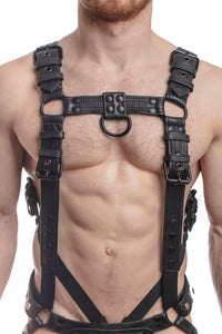 A 1.5" wide ARMY OF MEN FULL COMBAT KIT - Black connected to a cockring and a jockstrap, worn by a male model.