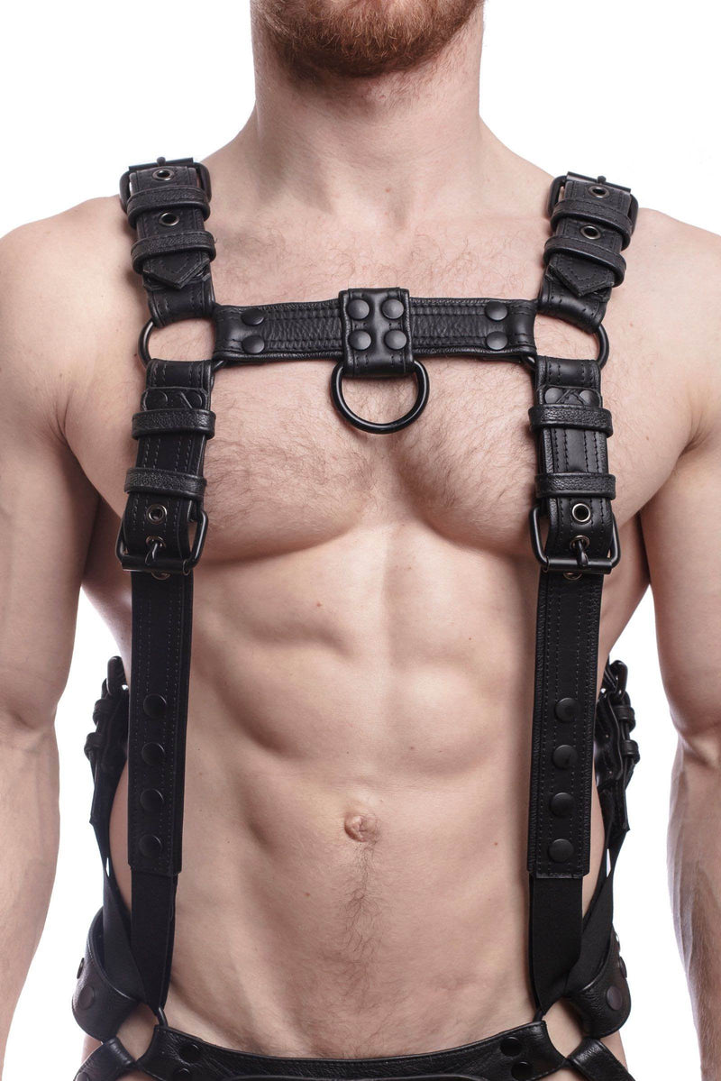 A male model wearing a 1.5" wide ARMY OF MEN black leather Full Combat Kit connected to a jockstrap, front facing view.