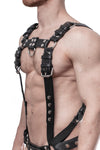 A chiselled model in three-quarter pose in a 1.5" wide black leather Full Combat Kit, connected to a jockstrap.
