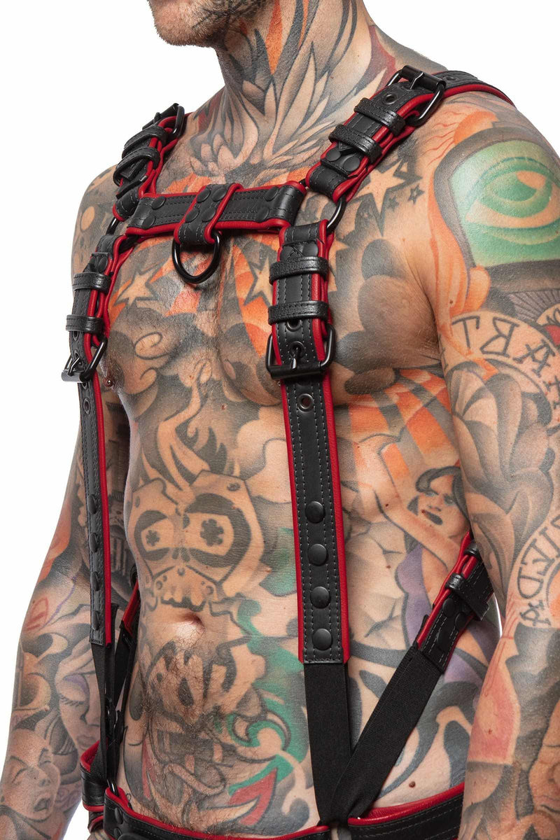 Three-quarter view of male model in a 1.5" wide ARMY OF MEN FULL COMBAT KIT - Red, connected to a jockstrap.