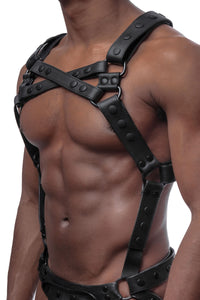A leather Full Universal X Kit with black O-rings on a male model, seen in a three-quarter profile. Front straps crossed.