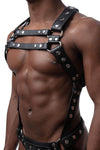 Male model in three-quarter pose wearing a leather Full Universal X Kit with stainless steel O-rings. Front straps parallel.