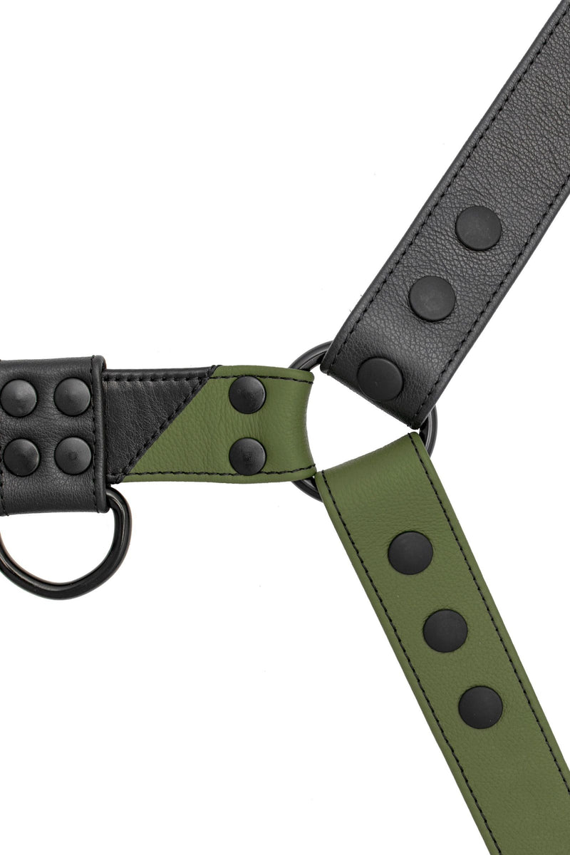 ARMY OF MEN black and army green leather chest harness with matte black metal hardware, displayed flat and viewed from above.