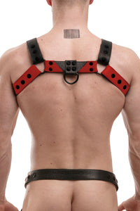Back view of male model in a 1.5" wide ARMY OF MEN black and red leather Chevron Bulldog harness with matte black rivets.