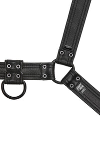 Flat-laid and facing down an ARMY OF MEN black leather bulldog harness with matte black O-rings revealing the lining leather.
