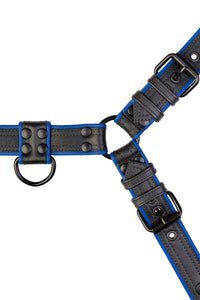 Overhead view of a 1.5" wide ARMY OF MEN blue and black leather harness with black rivets, buckles, O-rings, and D-rings.