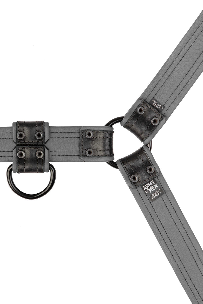An ARMY OF MEN grey and black leather Combat Bulldog harness with matte black hardware, laid flat and revealing the lining.