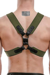 Male model in a 2" wide army green and black leather chest harness with matte black rivets, snaps, and O-rings, back view.