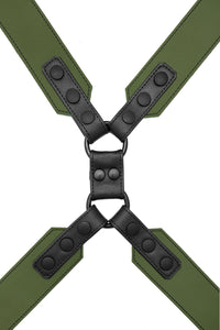 A 2" wide ARMY OF MEN army green and black leather chest harness with matte black O-rings, laid flat and viewed from above.