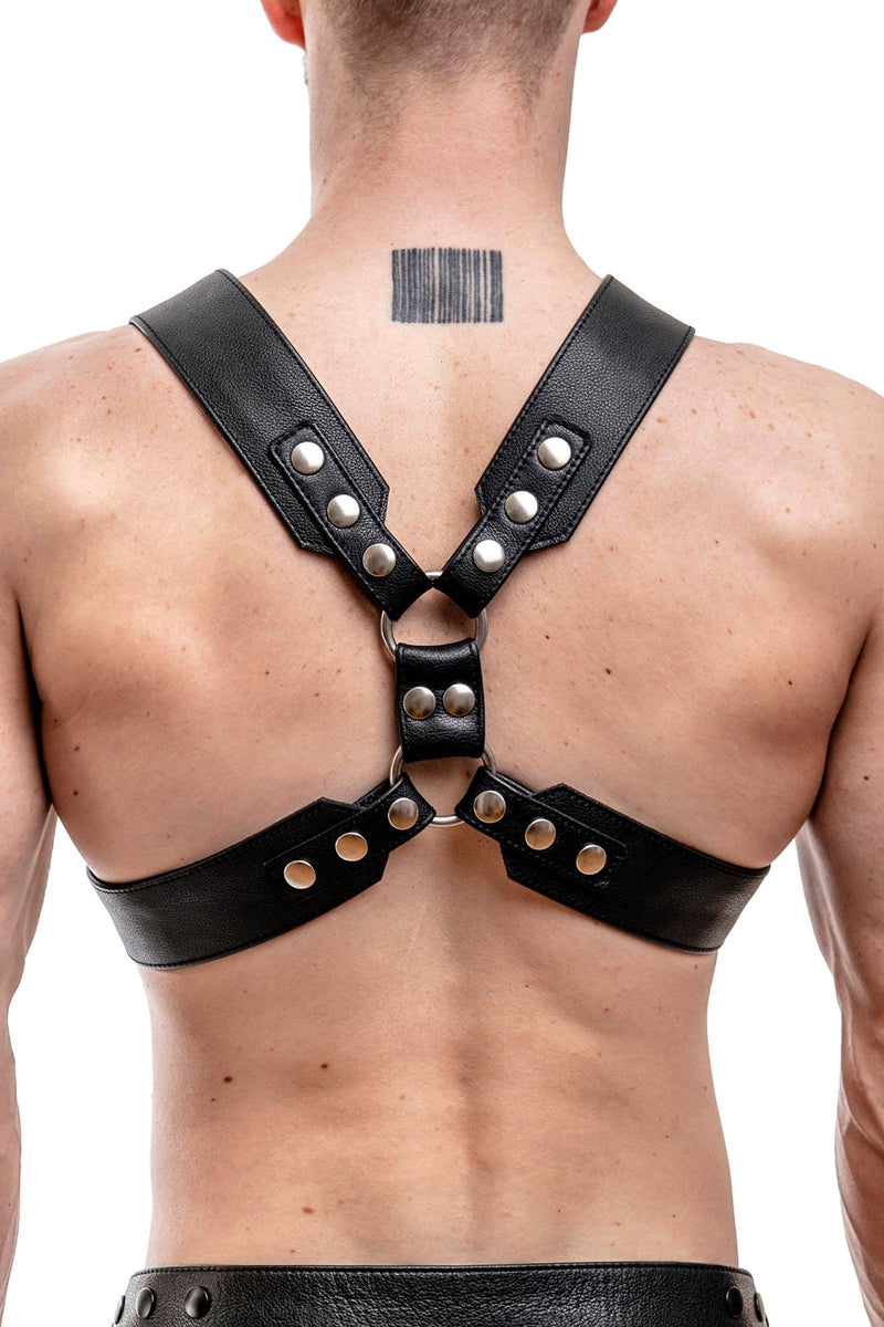 Rear view of male model wearing a 2" wide ARMY OF MEN black leather chest harness with stainless steel snaps.