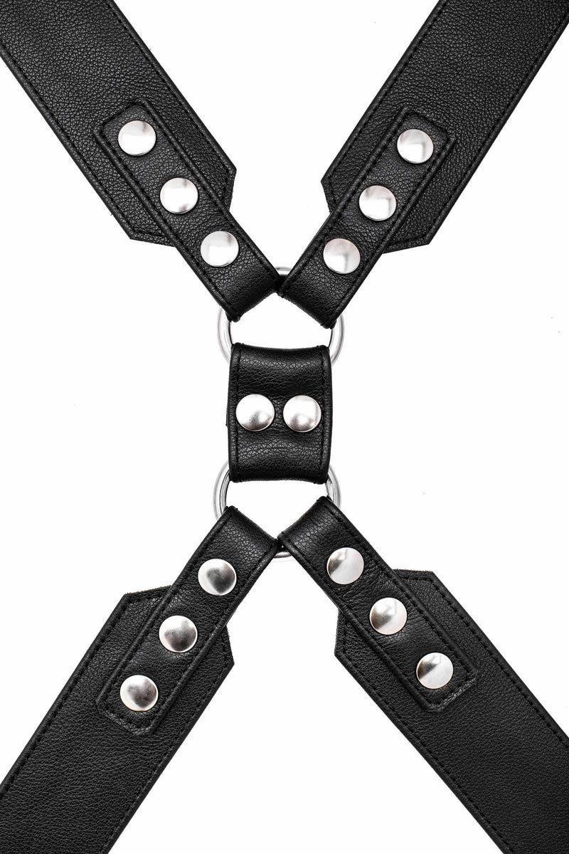 A 2" wide ARMY OF MEN black leather chest harness with stainless steel hardware, laid flat and captured from above.