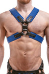 A 2" wide ARMY OF MEN COMMANDER X HARNESS - Blue with matte black hardware, worn by a chiselled model.