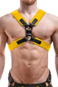 A ginger haired model wearing a 2" wide ARMY OF MEN COMMANDER X HARNESS - Yellow with matte black rivets, front facing view.