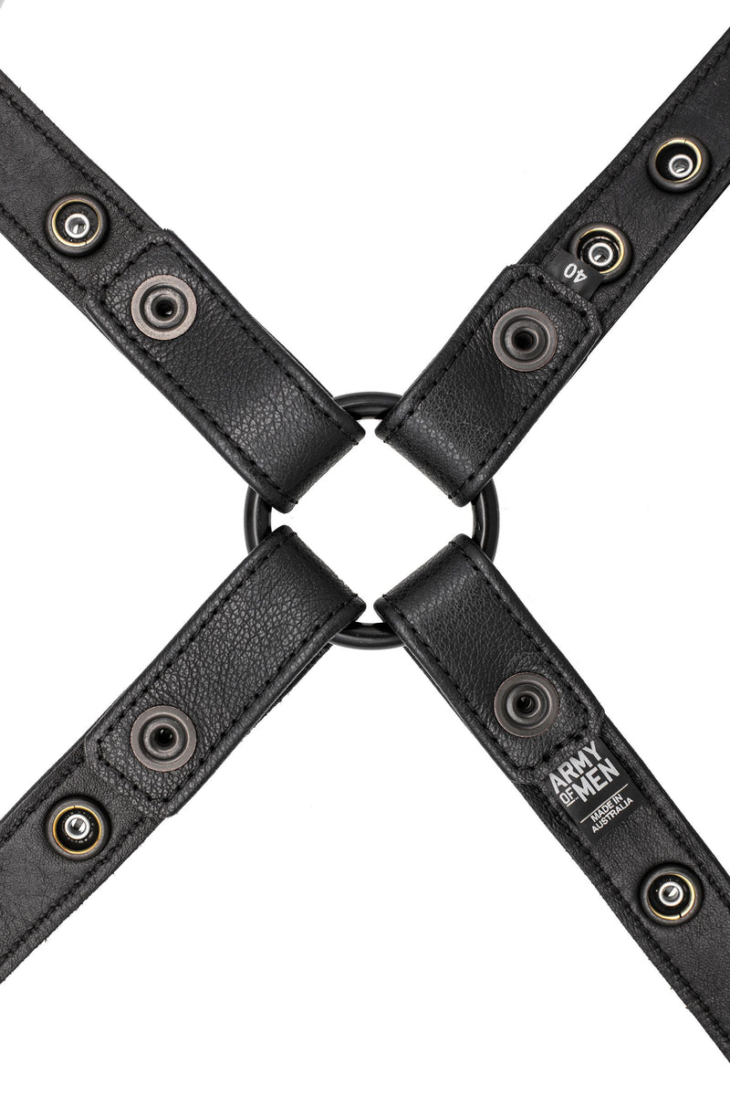 A 1" wide ARMY OF MEN black leather harness with matte black hardware, laid flat and showing the lining leather.