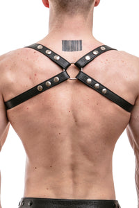 A ginger haired model in a 1" wide ARMY OF MEN black leather shoulder harness with stainless steel metal hardware, back view.