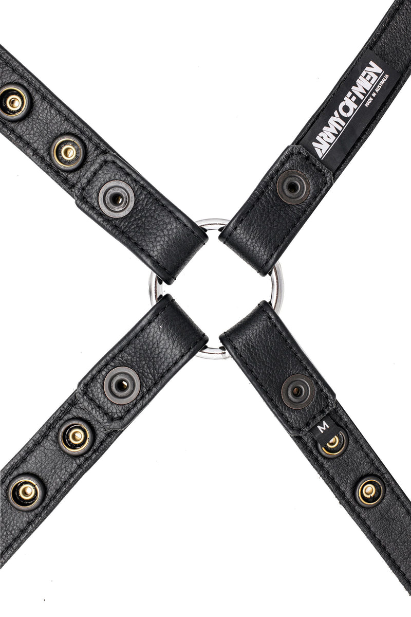 A 1" wide ARMY OF MEN black leather harness with stainless steel O-ring, displayed flat and revealing the lining leather.