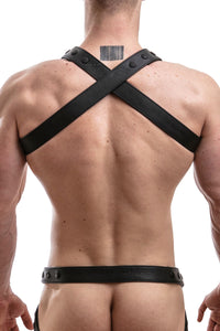 Rear view of male model wearing an ARMY OF MEN UNIVERSAL X HARNESS - Fluro with black rivets, snaps, and D-rings.
