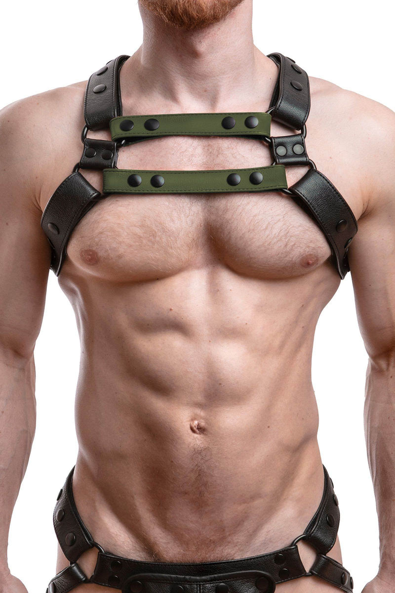 Front-on shot of a model wearing an ARMY OF MEN UNIVERSAL X HARNESS - Army Green with black hardware. Front straps parallel.