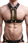 Front facing model in a UNIVERSAL X HARNESS - Army Green with matte black hardware, worn vertically. Front straps parallel.
