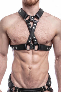 ARMY OF MEN black leather chest harness with stainless steel rivets styled on a male model, facing forward.