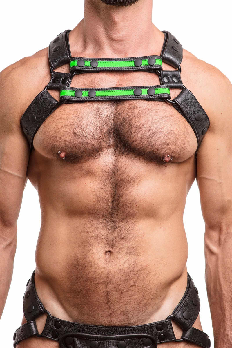 Model facing forward in an ARMY OF MEN UNIVERSAL X HARNESS - Fluro Green with matte black hardware. Front straps parallel.