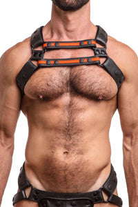 ARMY OF MEN black and fluro orange leather X harness with matt black rivets styled on a male model. Front straps parallel.